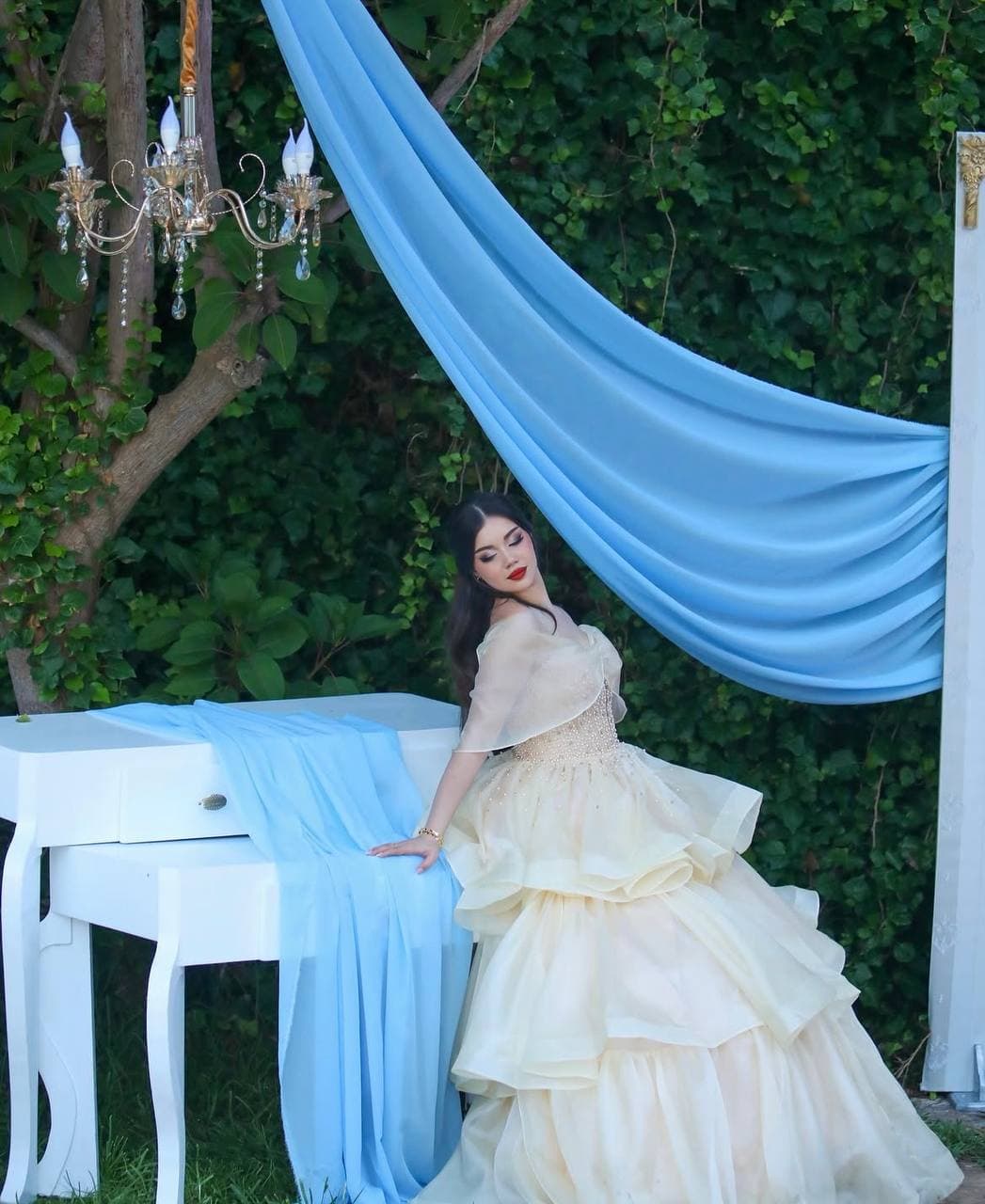 Tiered organza gown with a draped backdrop