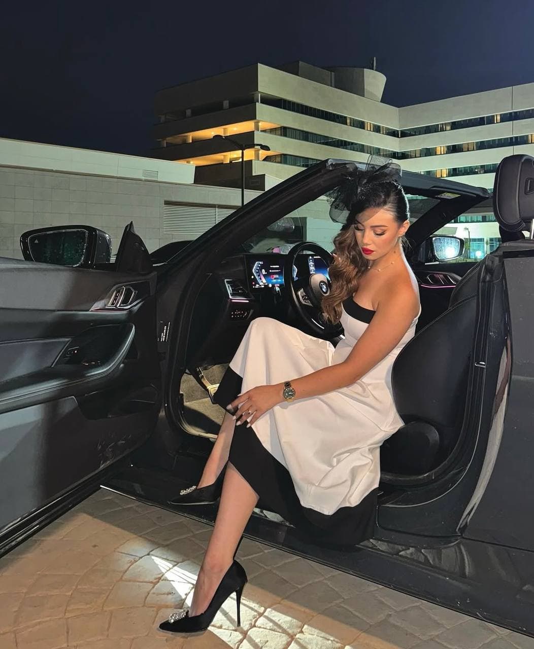 Melissa Belhouchet in a black and white evening gown at night